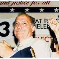 Color photo of mayoral candidate Tom Vezzetti with supporters in front of his campaign headquarters on election night, Hoboken, [June 11, 1985].