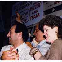 Color photo of mayoral candidate Tom Vezzetti with supporters in front of his campaign headquarters on election night, Hoboken, [June 11, 1985].