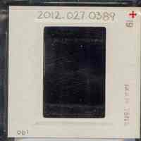          Color slide of close-up view of row house façades, cornices, brackets and bay windows including storefront signage reading 