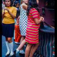 Color slide of three girls at a street fair.