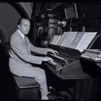 B+W photo negative of St. Matthew Lutheran Church interior, organist at keyboard, Hudson and 8th Sts., Hoboken, no date, ca. 1955-1956.