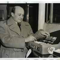 B+W photo of Paul E. Mayer showing WWI German war decorations on arrival by ship at Hoboken, March 27, 1940.