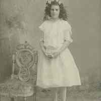 B+W photo of "Mayma" (Madeline Miller?) wearing floral garland & posed in photographer