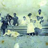 Digital image of photo of Julius Durstewitz plus 3 men and six woman on a beached rowboat, , no place (probably not Hoboken), no date, circa late 1910-1920.
