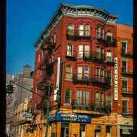 Color slide of eye-level view of front and side façades with fire escape at 76 River on the NW corner of River and Hudson Place occupied by the American Hotel