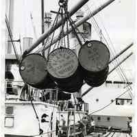 B+W photo of drums of olive oil being unloaded from S.S. Exporter, American Export Lines, Hoboken, N.J., July 16, 1962.