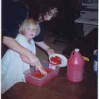 Color photo of Amy Young and female Glenwood Primary School student preparing paint for Georgia Children