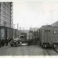 B+W photo of revenue agents unloading seized contraband liquor from rail car at 15th St., Hoboken, Jan. 21, 1933.