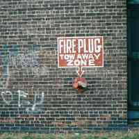 Color photo of a fire standpipe and painted wall sign of 722 Grand St., Hoboken, Jan. 3 & 4, 2002.