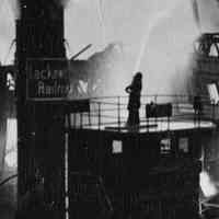          detail center: fireman with line on tugboat
   