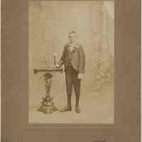 Sepia-tone photo of boy posed in photographer