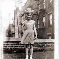 Sepia-toned photo of a young girl wearing a fancy head-dress on roof top probably 108 Tenth St., Hoboken, no date, ca. 1926-1928.