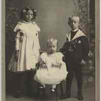Sepia-tone photo of an unidentified baby, ca. 1-2 years old, a boy and girl posed studio, Hoboken or Jersey City, no date, ca. 1890-1900.