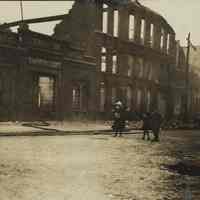 Sepia-tone photo of exterior view of the aftermath of fire at John Schmalz