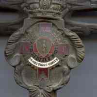          detail enameled cartouche at crossguard
   