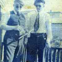 Digital image of photo of two men wearing ties, caps and sunglasses on a porch, no place (probably not Hoboken), no date, circa late 1910-1920.
