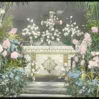 Lantern slide, color, of a church interior with floral decorations, used for promotional display in Hoboken, no date, ca. 1920.