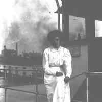 B+W negative image of an unidentified woman near what appears to be the wheelhouse of a ferry, dayliner or coastal steamer, no place, no date, ca. 190