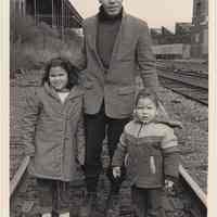 B+W photo of William Dejusus with his children walking on west side tracks ca. 16-17th Sts. , Hoboken, n.d, ca. 1983-1988.