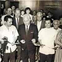 Digital image of black-and-white photo of a ribbon cutting ceremony inside D & V Barber Shop, 1032 Washington St., Hoboken, 1966.