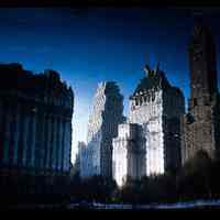 Color slide of buildings reflected in water.