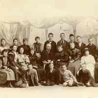 Sepia-tone group photo of man, woman & children of various ages; Louise Sanntrock in group. Location not known, n.d., ca. 1890s.