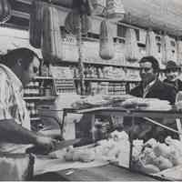Reference image of printed photo image of interior of an Italian deli or salumeria from pg 21 of archives catalog 2002.026.0002, Hoboken, ca. 1975.