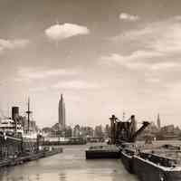 B+W photo of crane barge operations in dry dock area; vessel S.S. Gloria in dry dock north, Hoboken, no date, ca. 1940.