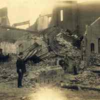 Sepia-tone photo of exterior view of the aftermath of fire at John Schmalz