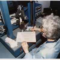 Color photos, 8, of U.S. Testing Co. employee Helen Miller operating test equipment, Hoboken, Apr. 1977.