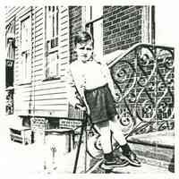 Black-and-white photocopy of photo of Wayne Ratti on the front steps of 721 Adams St., Hoboken, 1950.