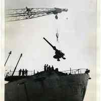 B+W photo of deck gun being lifted off Liberty ship William Wirt at Todd Shipyards, Hoboken, July 16, 1945.