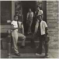 B+W photo of a group of young men standing outside the entrance to The Astor, Hoboken, no date, [1976].