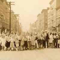 Digital image of photo of large group of young children on unidentified Hoboken st. carrying American flags, n.d., ca. late 1920