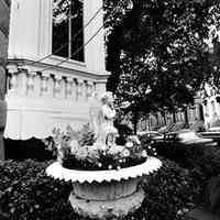 B+W photo of a cast-iron urn planter with an angel sculpture at 169 11th St., southeast corner of Garden & 11 Sts., Hoboken, no date (ca. 1968-72)