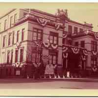 Color photo of Hoboken City Hall, 94 Washington Street, decorated with bunting for Centennial, April 1955.