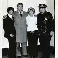 B+W photo of (from left) Marian Roland; Peter Roland; woman; policeman, City Hall(?), Hoboken, n.d., ca. 1965-1975.