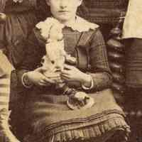          detail girl seated on floor with doll
   