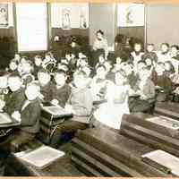 Digital image of a school classroom with young students and teacher, Hoboken, no date, ca. 1900-10.