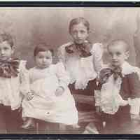 Cabinet photo of 4 children posed in fine dress, New York studio, n.d., ca. 1890-1895.