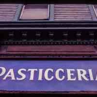          Color slide of close-up view of cornice and storefront signage reading 