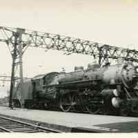 B+W photo of D.L. & W. R.R. steam locomotive 1115 near Lackawanna Terminal passenger shed, Hoboken, August 3, 1936.