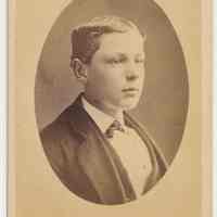 Sepia-tone photo of boy posed in photographer