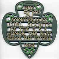 Painted metal trivet/plaque commemorating the 50th anniversary of the Girl Scouts in the U.S. 1962.