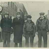 B+W photo of 4 men posed in the winter in front of the Model Garage, 214 Clinton St., Hoboken, no date, ca. 1927.