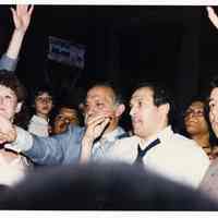 Color photo of mayoral candidate Tom Vezzetti in front of City Hall with supporters on election night, Hoboken, [June 11, 1985].