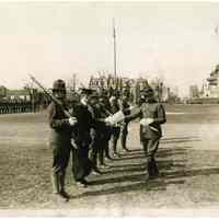 B+W photo of Stevens Institute of Technology students receiving diplomas in their Army uniforms at commencement during WWI, Hoboken, ca. Apr. 6-7, 1918.