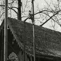          4: detail upper right, man in bosun's chair working on flagpole
   