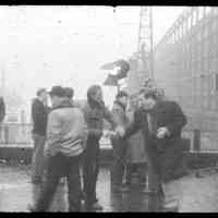 Color slide of Marlon Brando shaking hands of actor plus 10 men on pier set of the motion picture "On the Waterfront", Hoboken, n.d., ca. 1953-54.