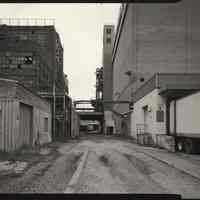 B+W photo of former Maxwell House Coffee plant exterior, looking north between Extraction Building & Storage Silos, Hoboken, 2003.